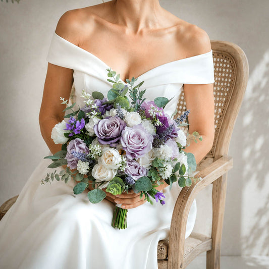 Lavender silk wedding bouquet with purple roses, ivory blooms and greenery