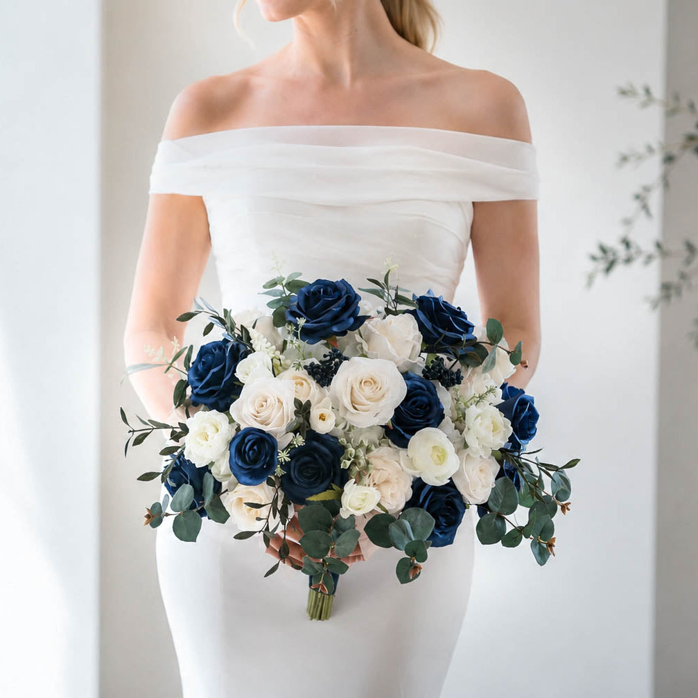 Navy blue and white silk wedding bouquet with ivory roses and eucalyptus greenery