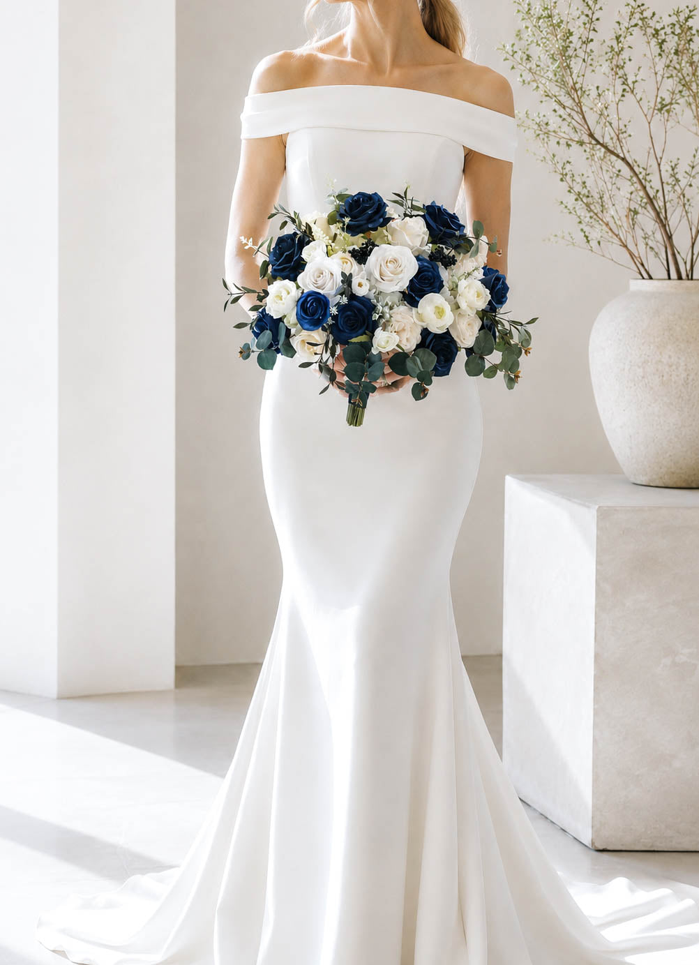 Bride holding silk navy blue and white  bridal bouquet with roses and eucalyptus