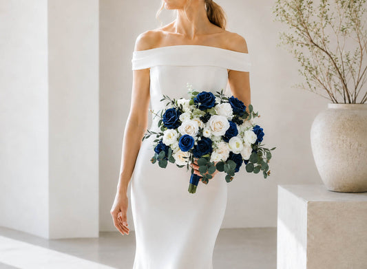 Bride holding navy blue and white silk bridal bouquet with roses and eucalyptus