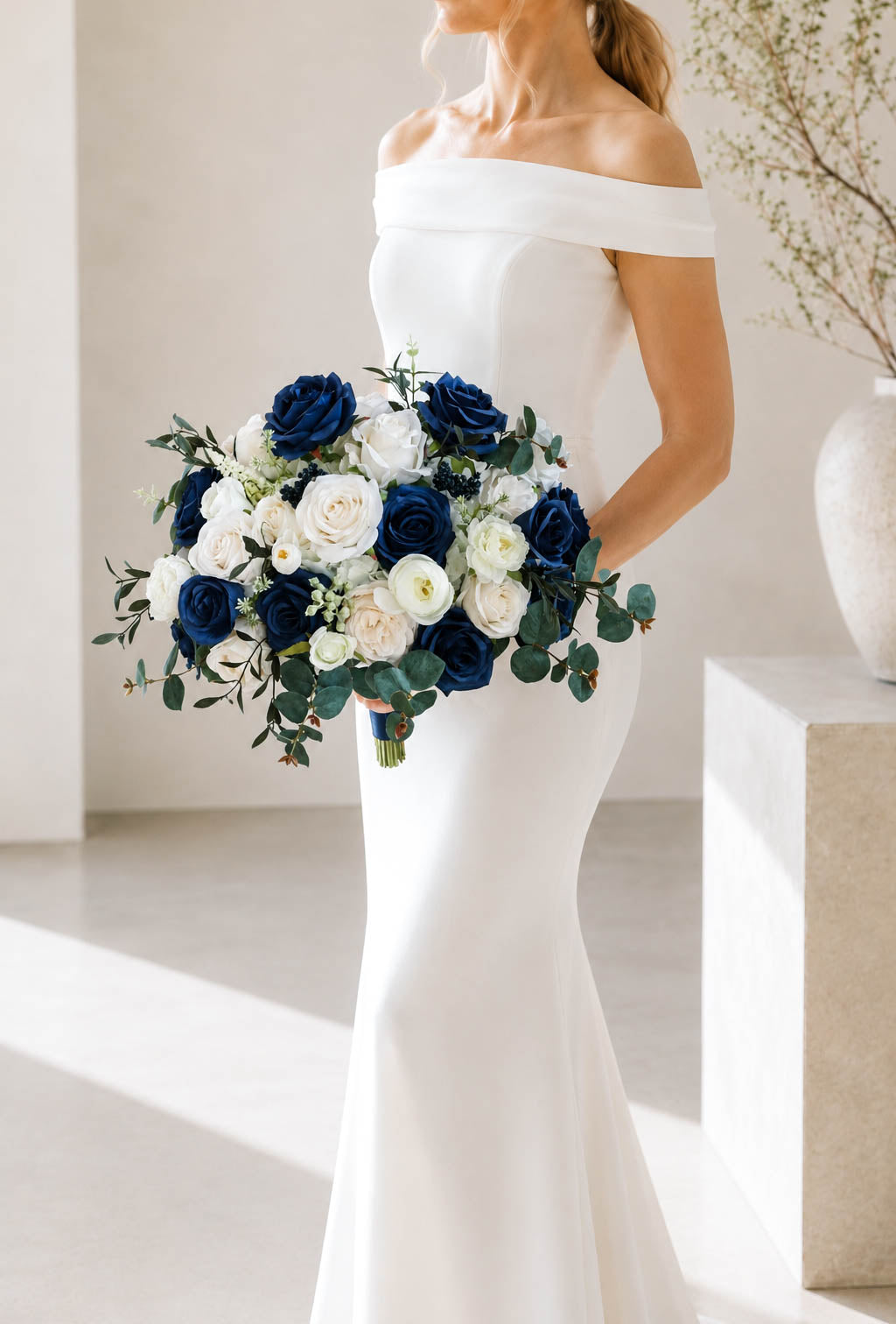 Navy blue and white silk bridal bouquet shown in an elegant wedding setting