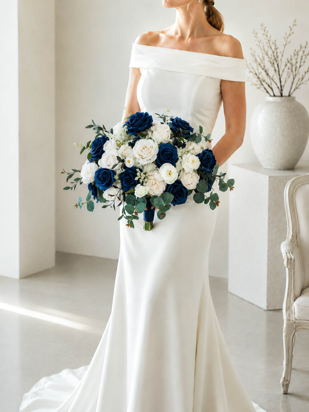 Navy blue and ivory silk wedding bouquet styled with a white bridal gown