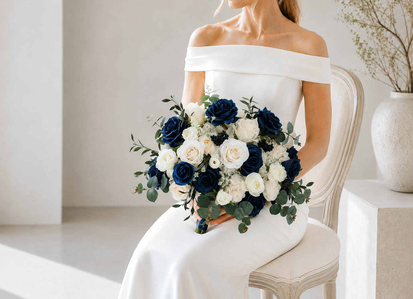 Close view of navy blue and white silk wedding bouquet with elegant rose details