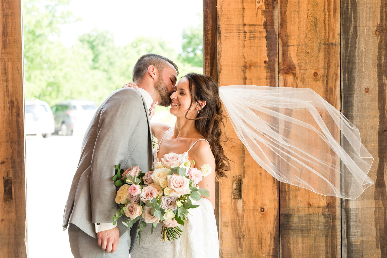 Bride and groom with garden-inspired bridal bouquet by Heaven Flowers