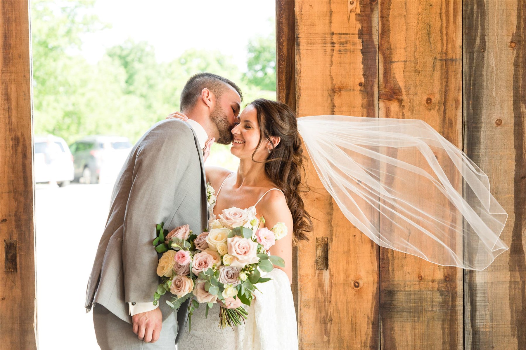 Bride and groom with garden-inspired bridal bouquet by Heaven Flowers